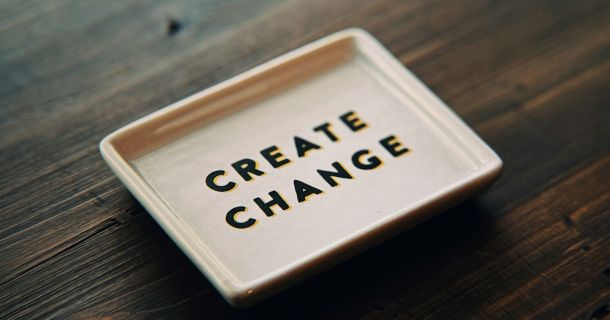 A white tray with the words create change written on it