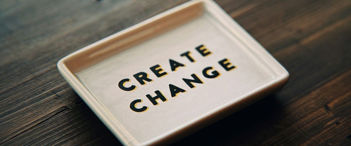A white tray with the words create change written on it