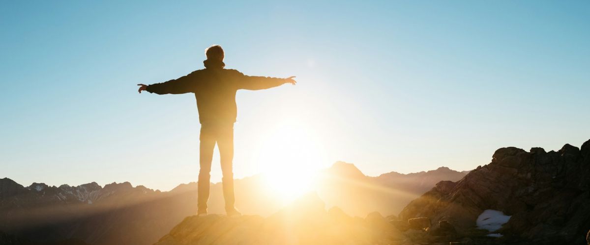 person standing on hill